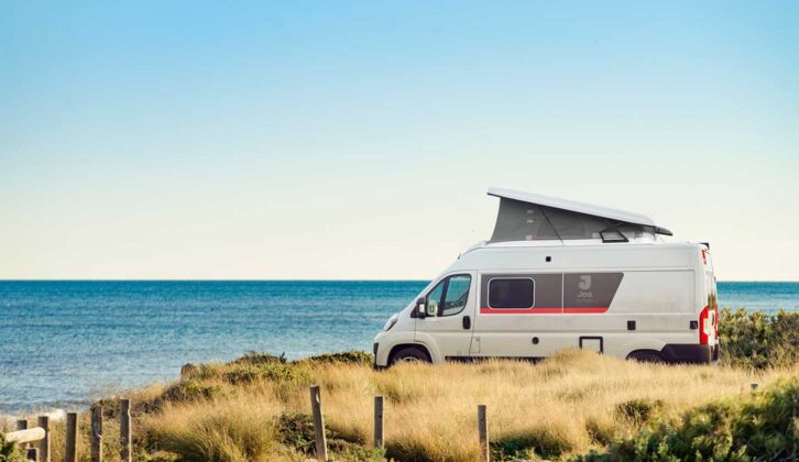 The 60G with its roof raised, parked by the sea