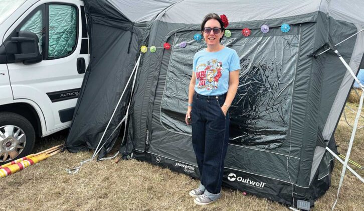 Sarah standing next to her campervan and awning