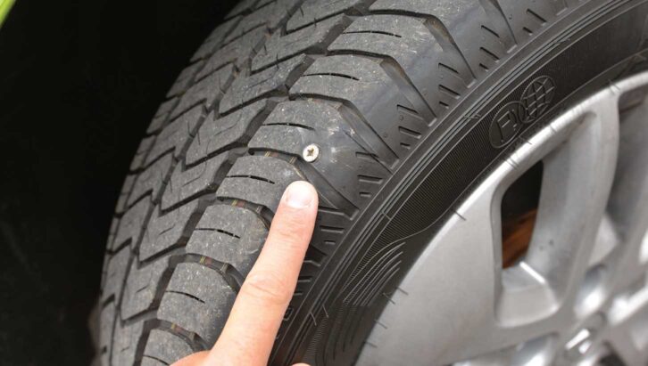 A tyre with a nail in it