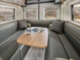 The rear lounge of the campervan with the moveable table set up