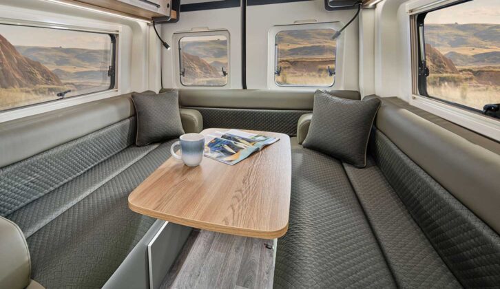 The rear lounge of the campervan with the moveable table set up