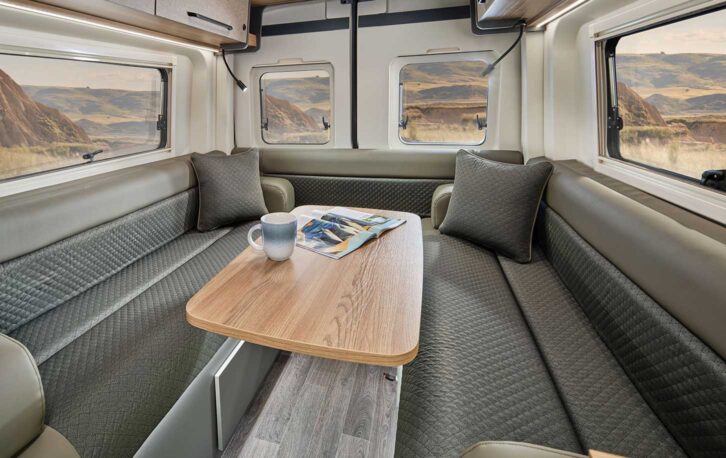 The rear lounge of the campervan with the moveable table set up