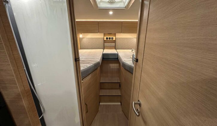 The fixed single beds at the rear