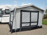 A motorhome with an awning erected next to it