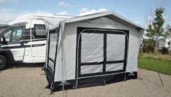 A motorhome with an awning erected next to it