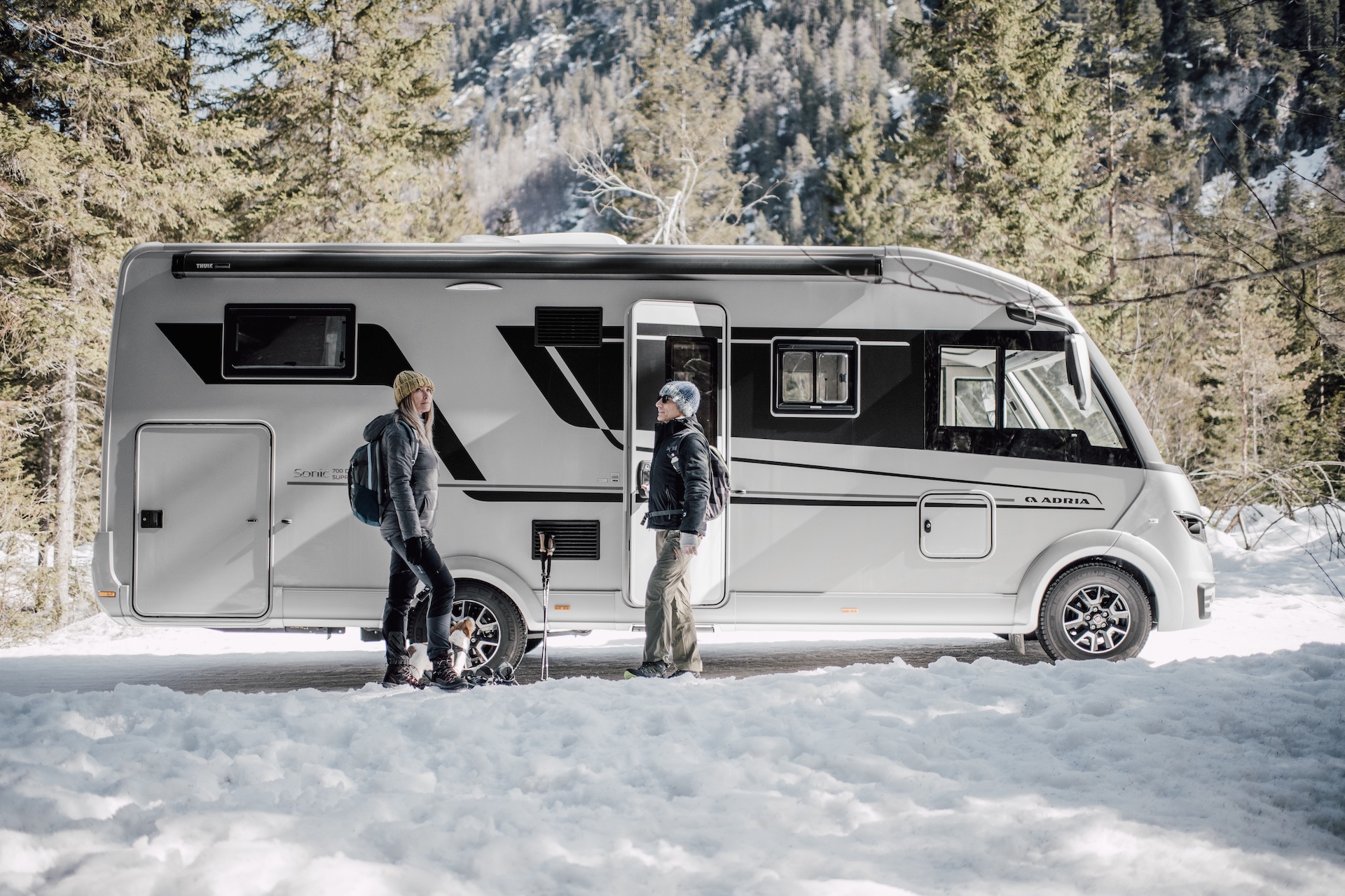 A couple outside an Adria Sonic motorhome