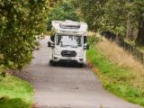 A motorhome driving down a country road