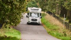 A motorhome driving down a country road