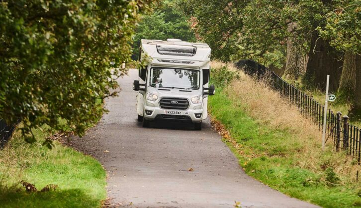 A motorhome driving down a country road