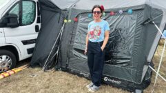 Sarah standing by her campervan and awning at Twinwood Vintage Festival
