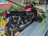 A motorbike on a covered trailer