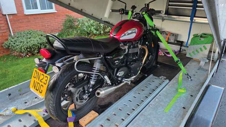 A motorbike on a covered trailer