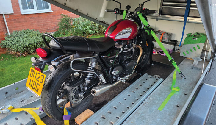 A motorbike on a covered trailer