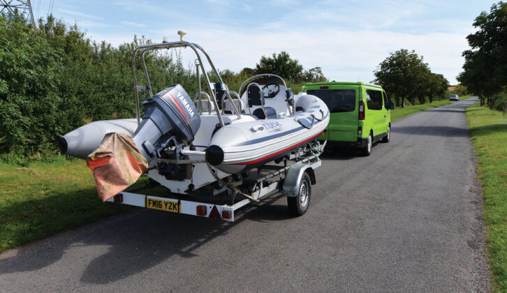 A RIB being towed by a campervan on a trailer
