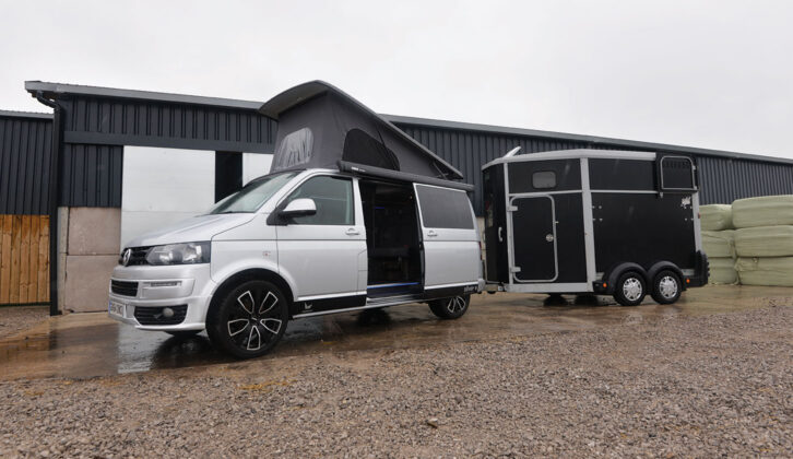 A campervan towing a horsebox