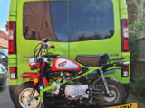 A motorbike on the back of a campervan
