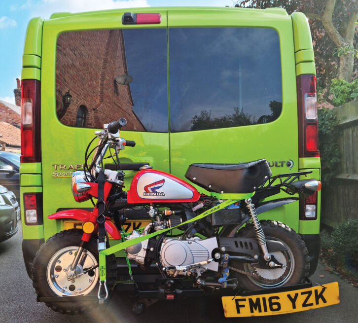 A motorbike on the back of a campervan