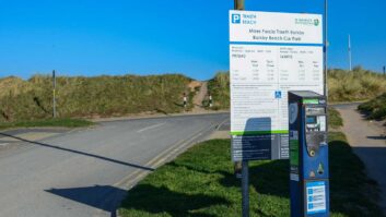 A sign at Barkby Beach Car Park showing costs for parking in 2022