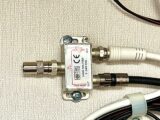 The splitter fitted with the F-type to co-ax TV adaptor attached