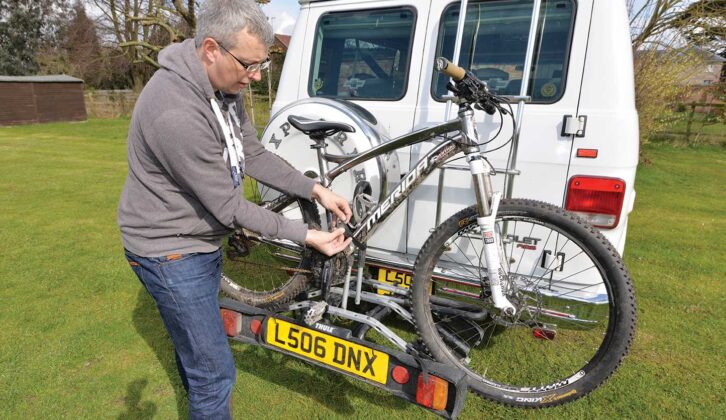 A Thule bike rack on the back of a campervan