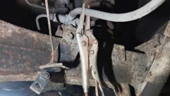 A pair of locking pliers on the rear brake hose