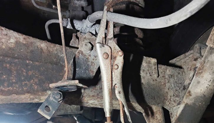 A pair of locking pliers on the rear brake hose