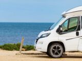 A motorhome parked by the sea with VanContact Ultra Camper