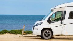 A motorhome parked by the sea with VanContact Ultra Camper