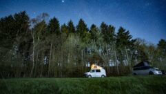 Campervan in the forest under the stars