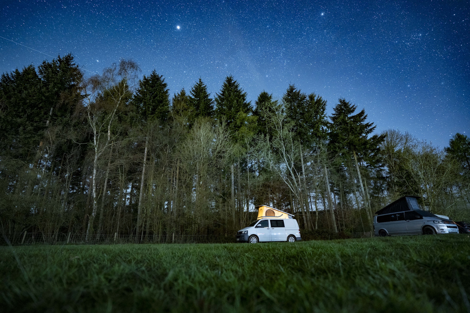 Campervan in the forest under the stars