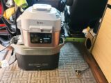 An EcoFlow portable power station with a Ninja air fryer on top of it