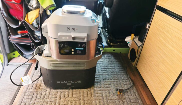 An EcoFlow portable power station with a Ninja air fryer on top of it
