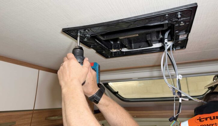 Screwing the air-con unit into place