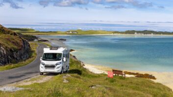 A motorhome parked in the Outer Hebrides with Barra Airport in the background