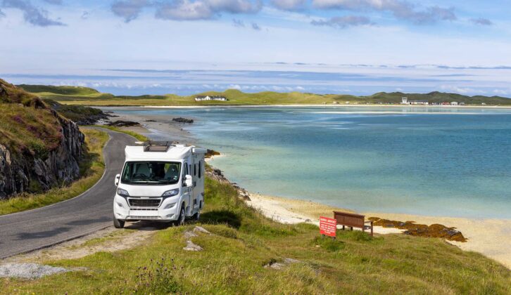 A motorhome parked in the Outer Hebrides with Barra Airport in the background