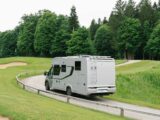 An Adria Coral Supreme motorhome being driven along a road