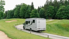 An Adria Coral Supreme motorhome being driven along a road