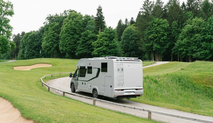 An Adria Coral Supreme motorhome being driven along a road