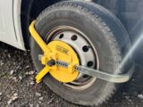 A wheel clamp in place on a 'van