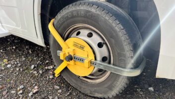 A wheel clamp in place on a 'van