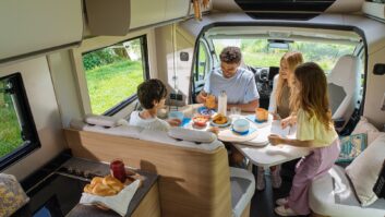 Family sitting around table of Adria Matrix dinette