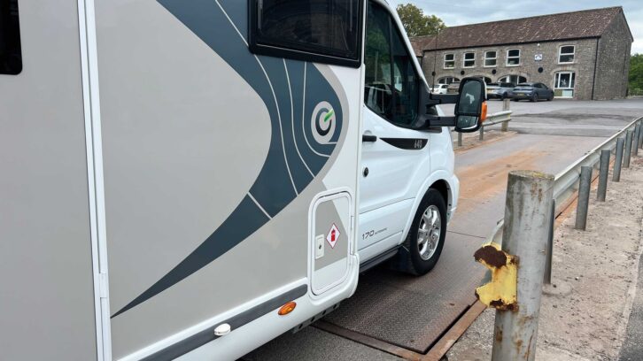 A motorhome being driven onto a weighbridge